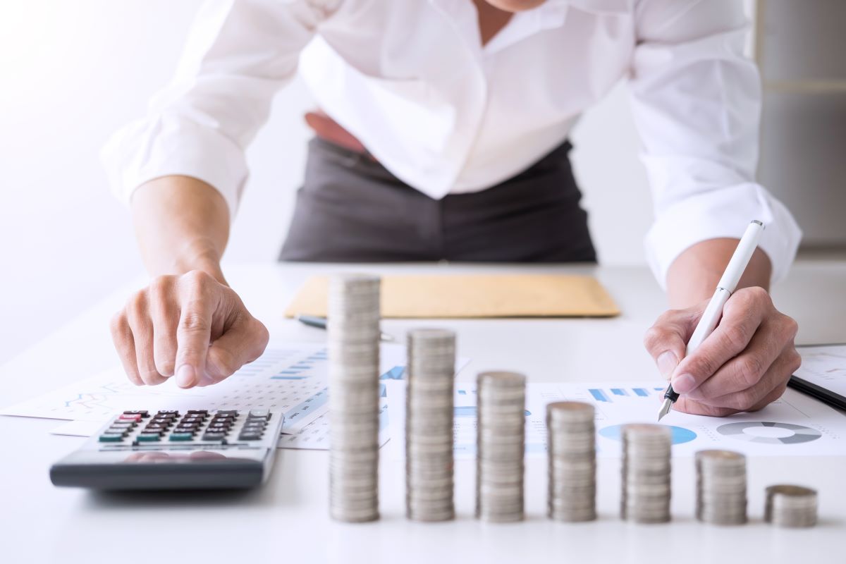 man counting money coins stacked