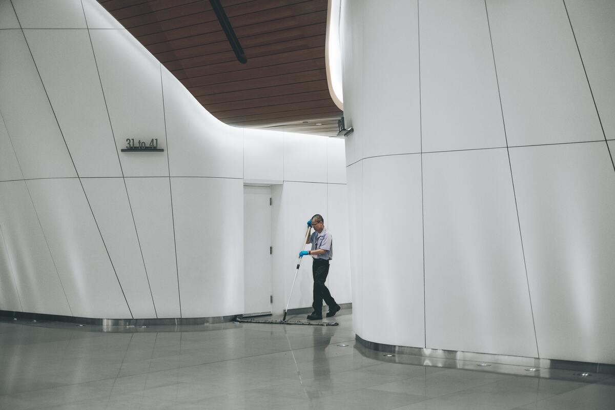 janitor cleaning hallways of office
