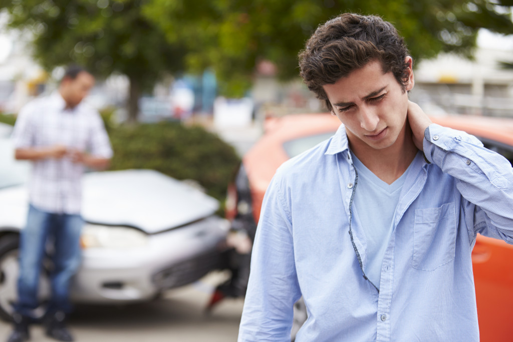 man aching from car accident