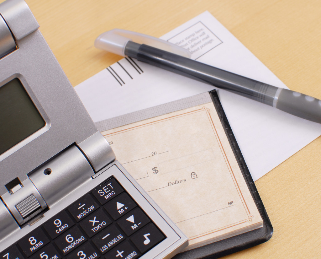 a calculator, pen, and cheque book
