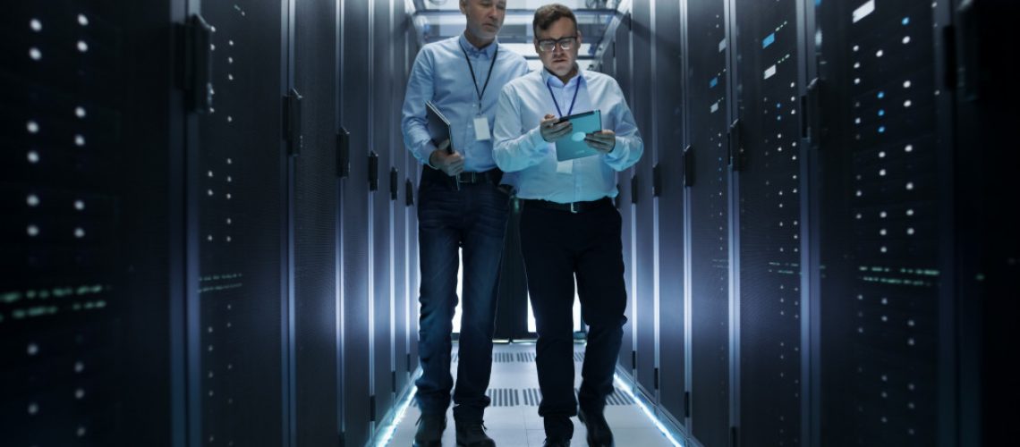 2 man walking in data center